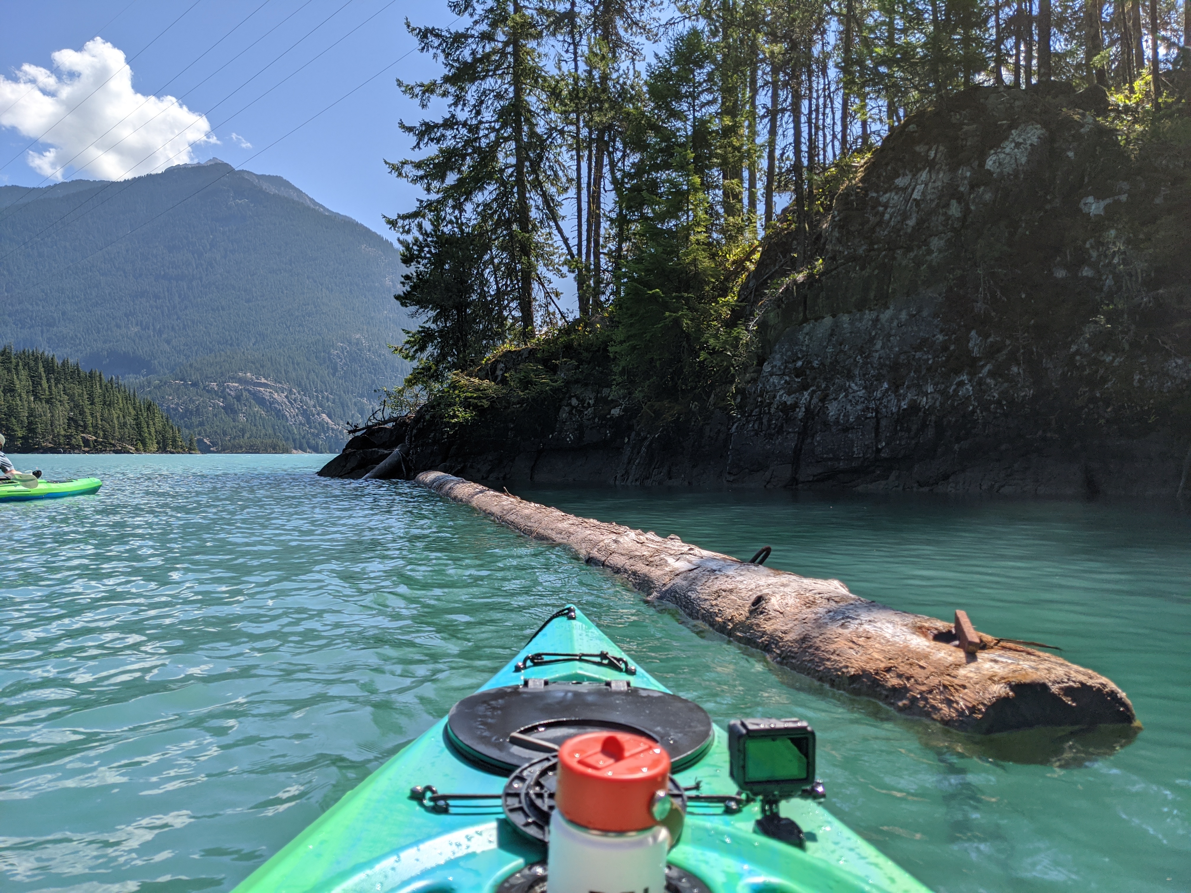 A kayak on a lake, next to a small rocky island beach
