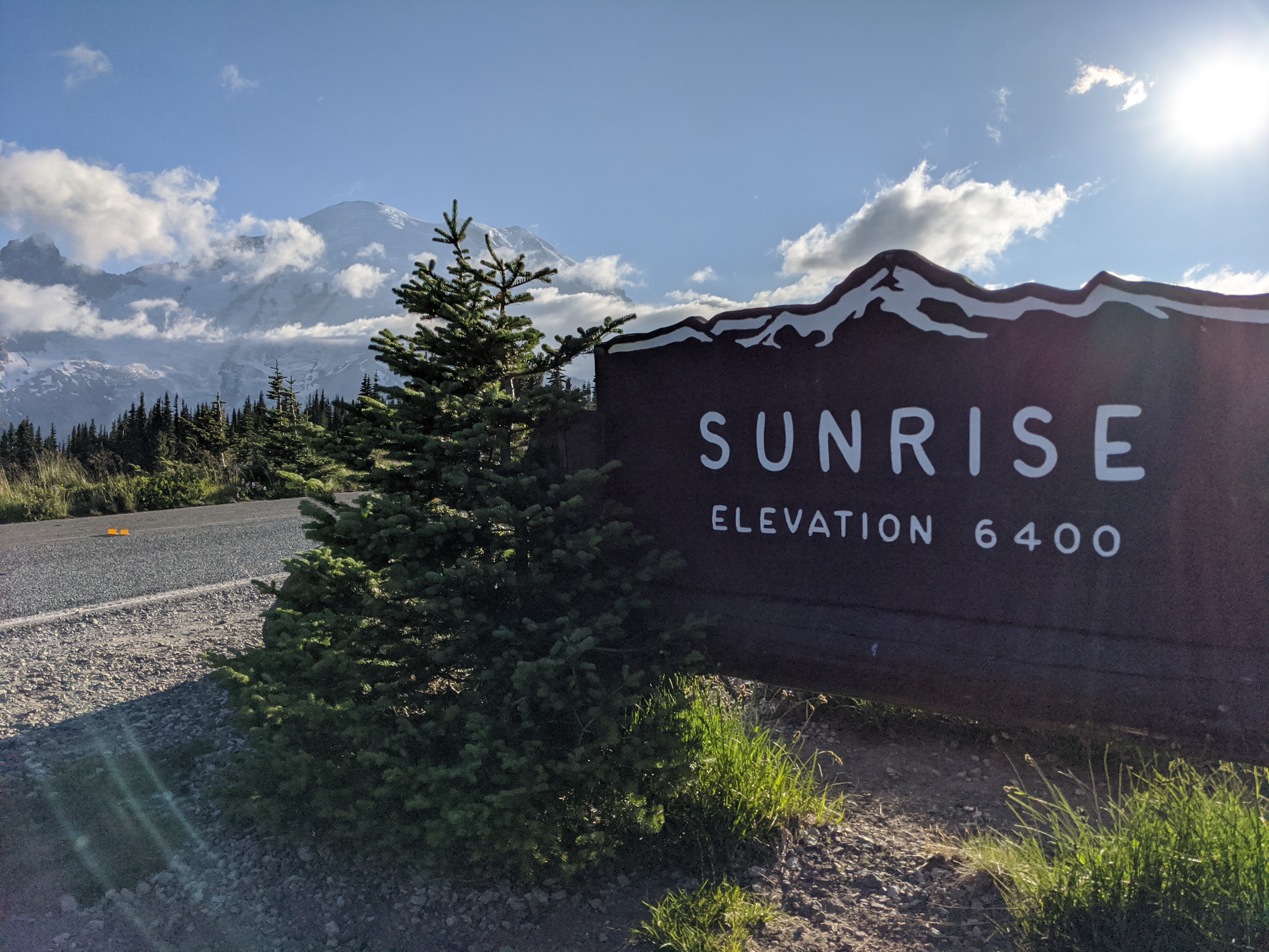 Sign reading out Sunrise, Elevation 6400 with Mount Rainier in the distance
